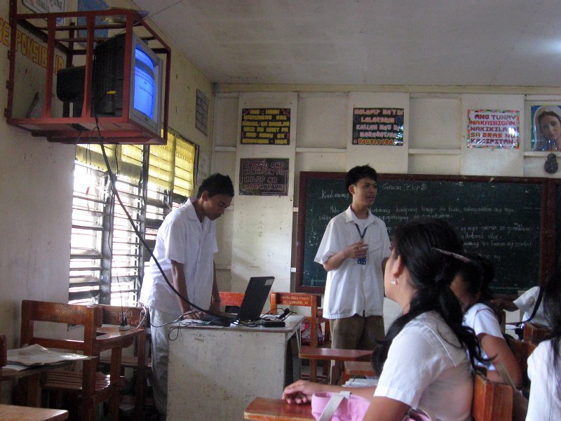 Student computer specialists teaching in classroom